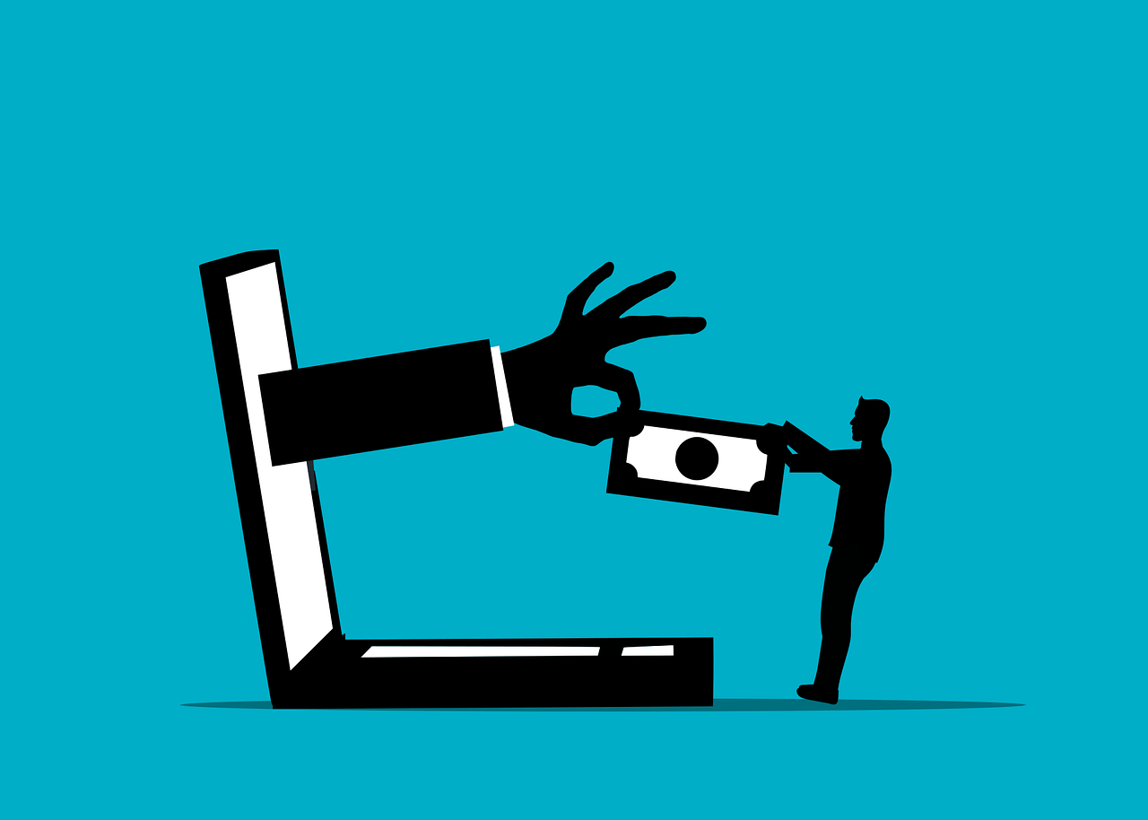 Online-Betrug Symbolbild Eine Hand kommt aus einem Computer und entwendet Geld