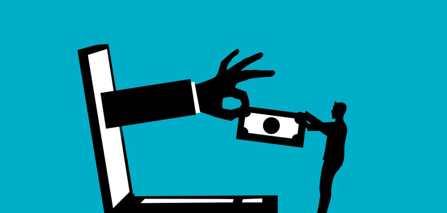 Online-Betrug Symbolbild Eine Hand kommt aus einem Computer und entwendet Geld