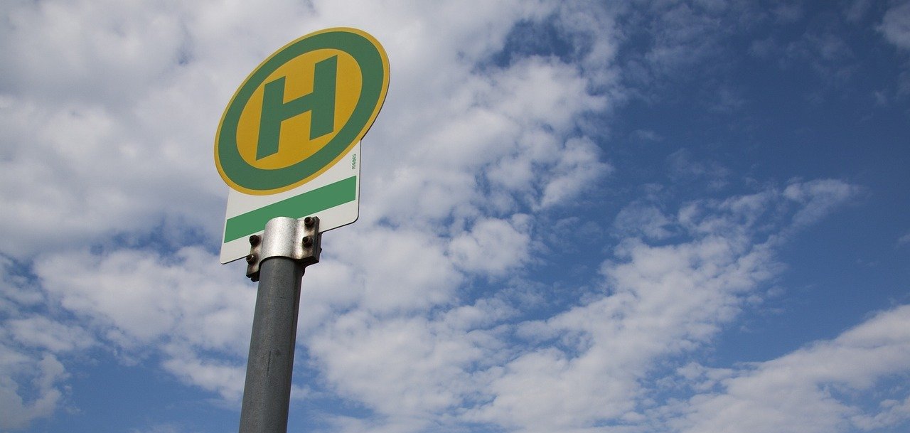Ein Bushaltestellenschild vor blauem Himmel